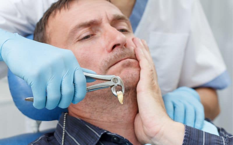 An elderly man had the dentist remove a broken tooth.