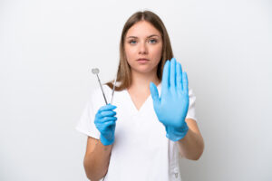 Dentist woman holding tools Refuse to Treat a Patient With HIV