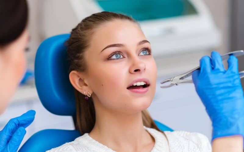 woman at dental office having a tooth extraction