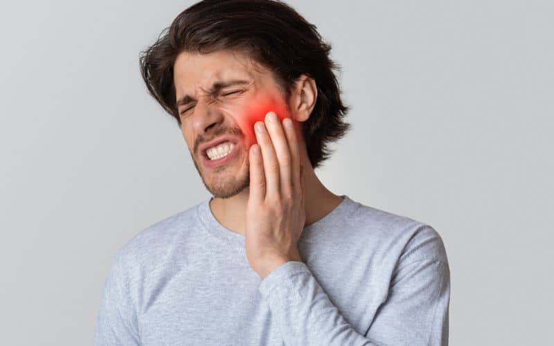 A male experiencing toothache
