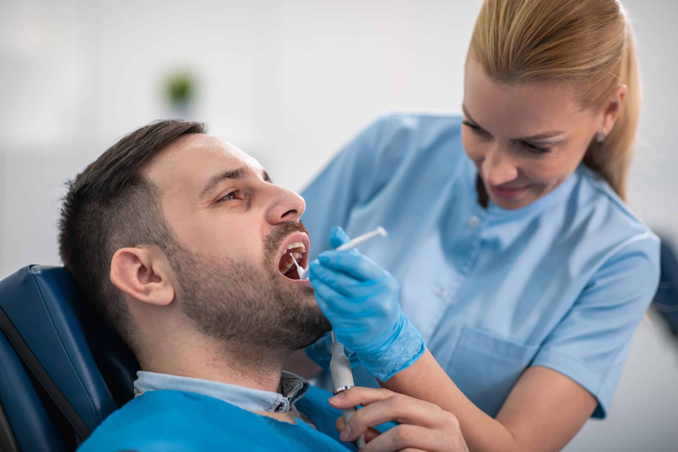 A man receiving a dental cleaning procedure