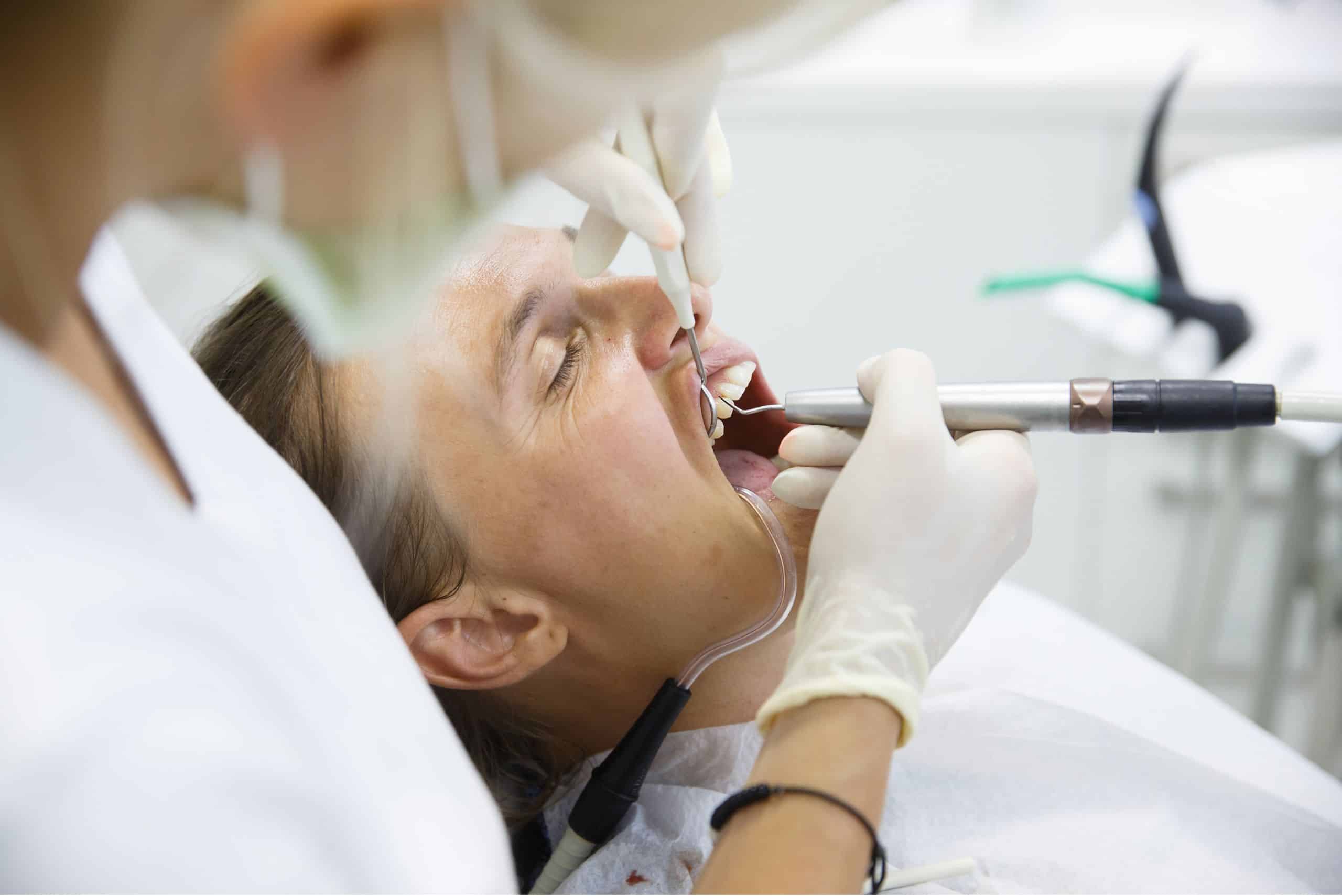 Individual undergoing dental care and various dental procedures at a dental clinic