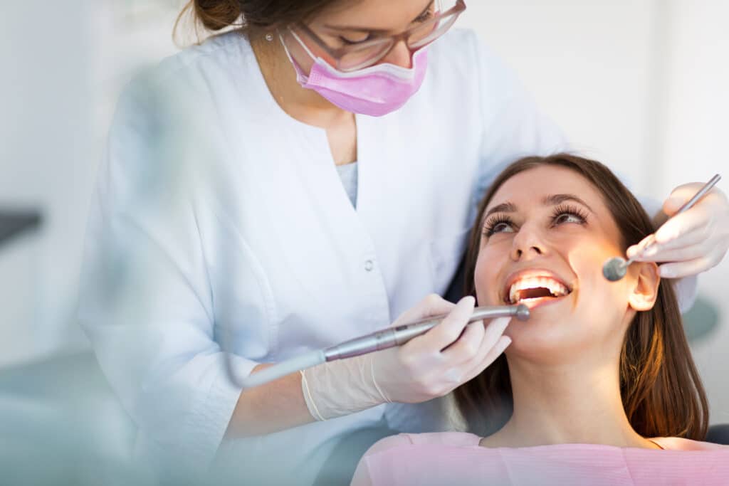 dentist and patient in dental office for regular check up