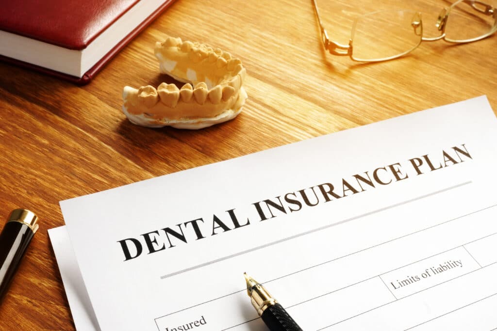 Dental insurance plan policy and glasses