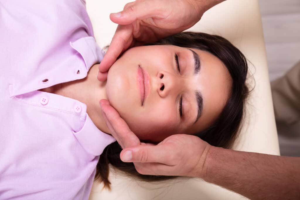 Young Woman Receiving Jaw Massage