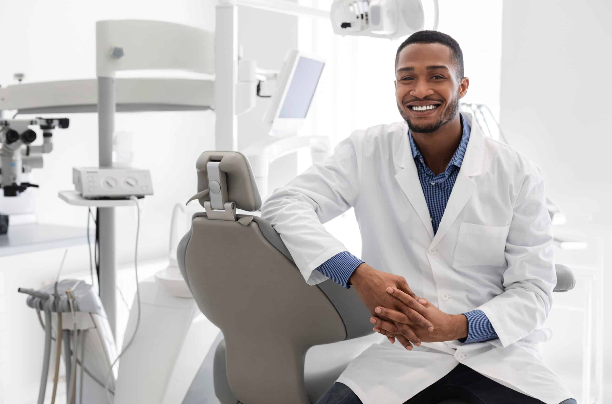 Highly qualified young black dentist posing at clinic