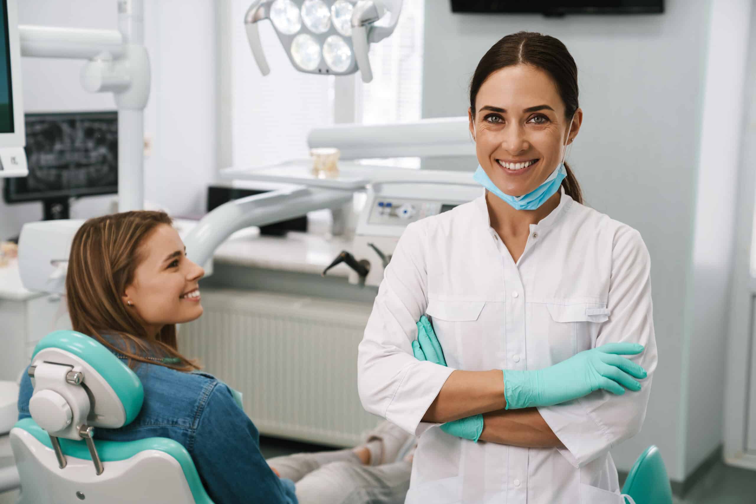 mid dentist woman smiling while working with patient in dental clinic