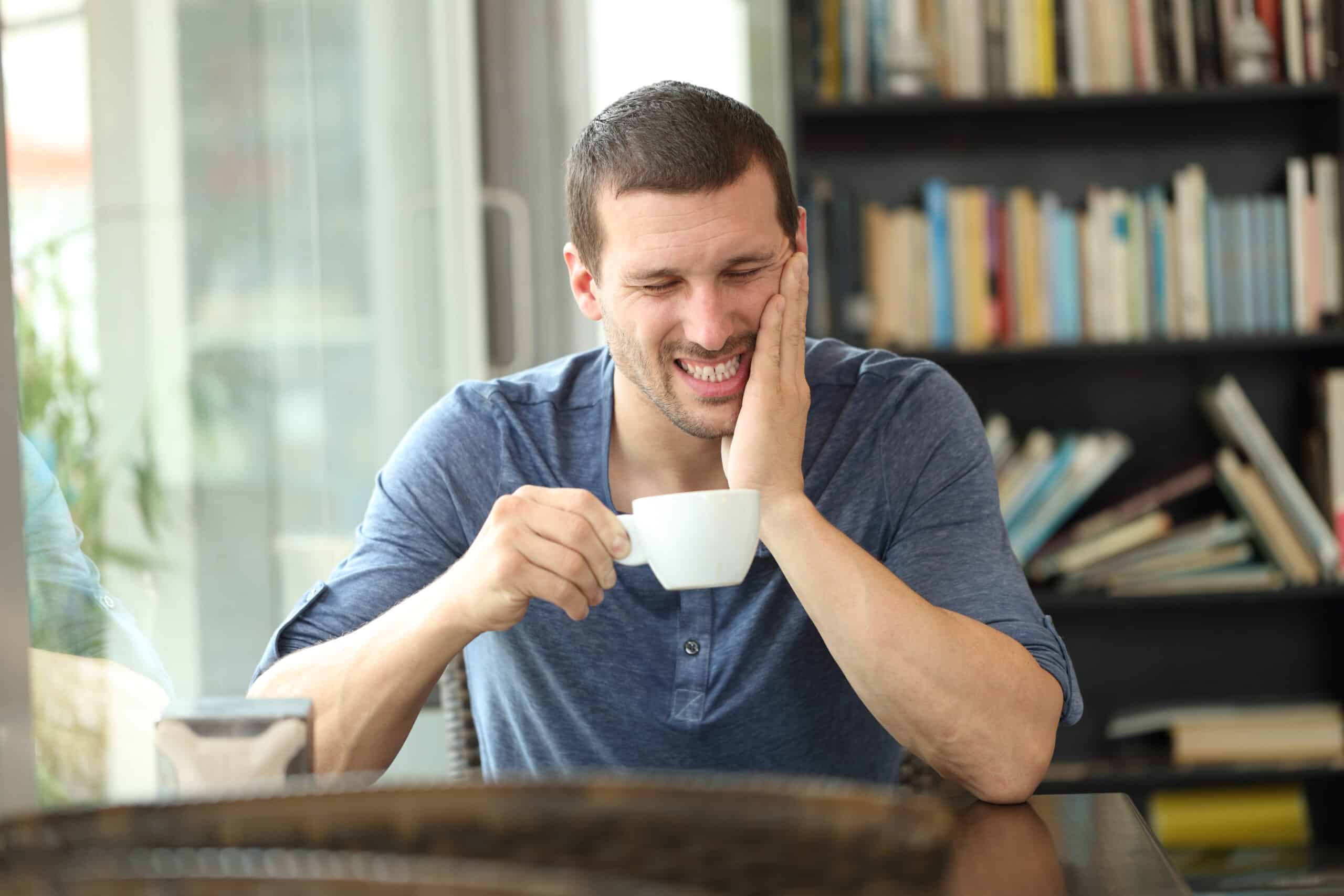  man complaining suffering tooth ache after drinking hot coffee
