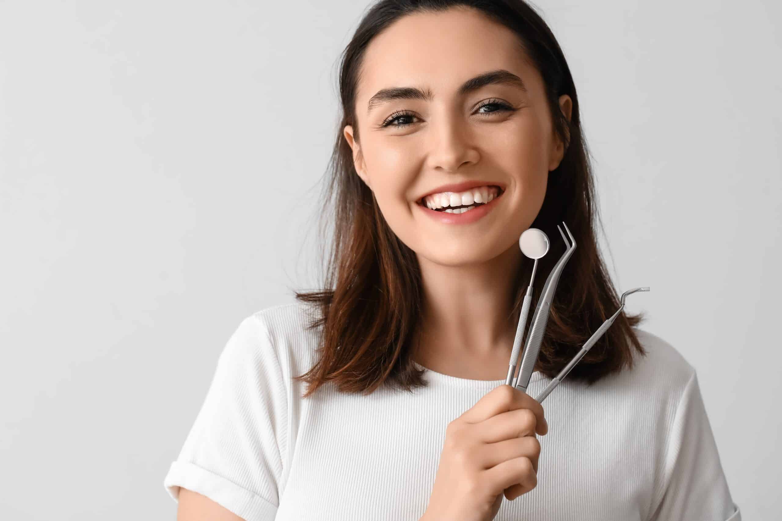Young woman with dental tools